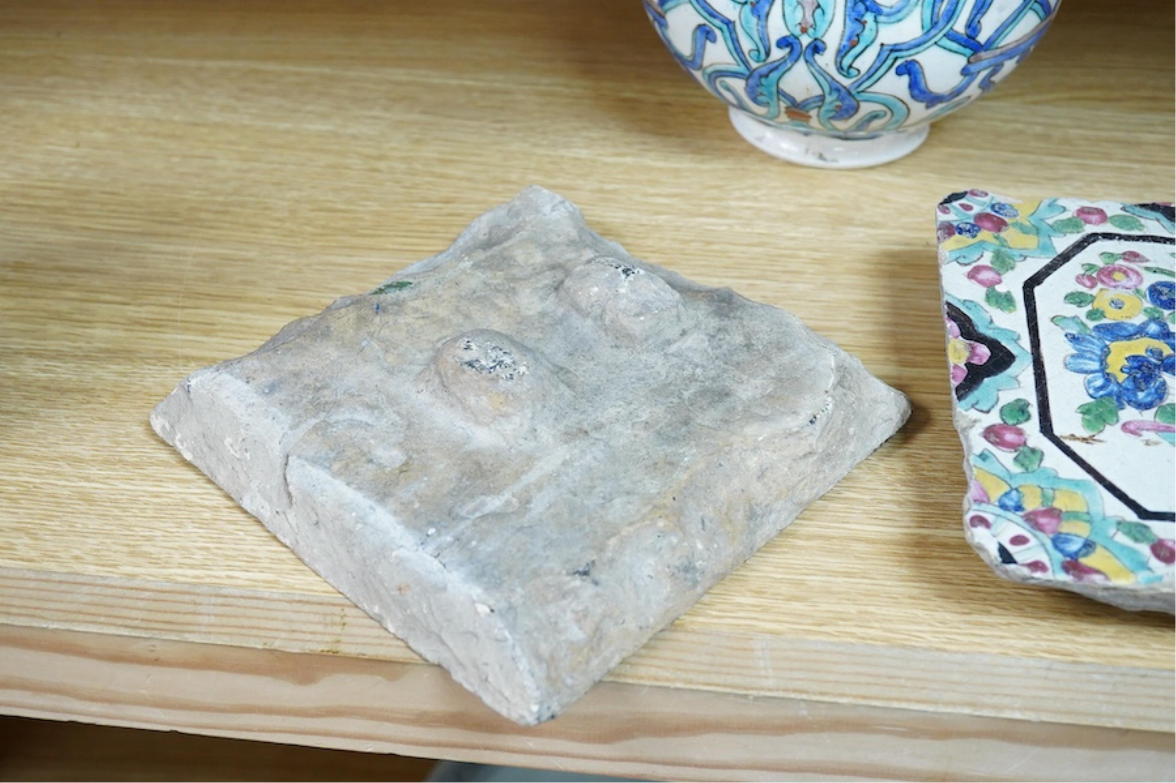 A Persian stoneware vase (reduced) and two floral tiles